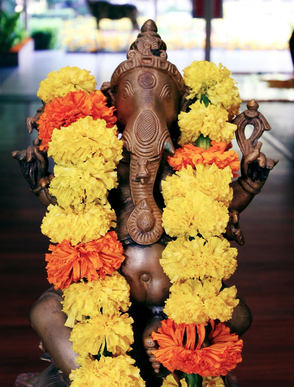 A marigold-adorned Ganesha idol at a Hindu puja