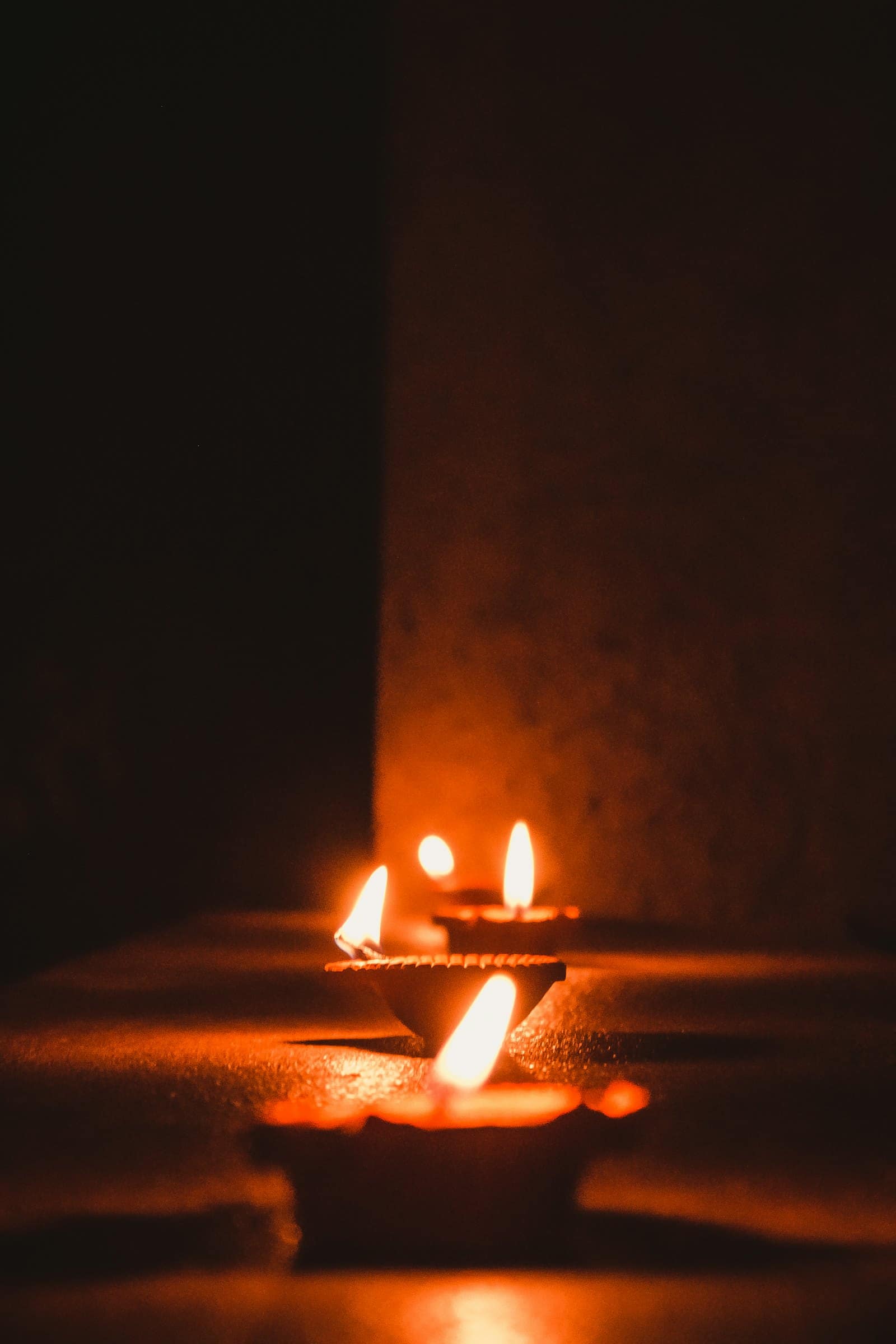 A row of lit diyas