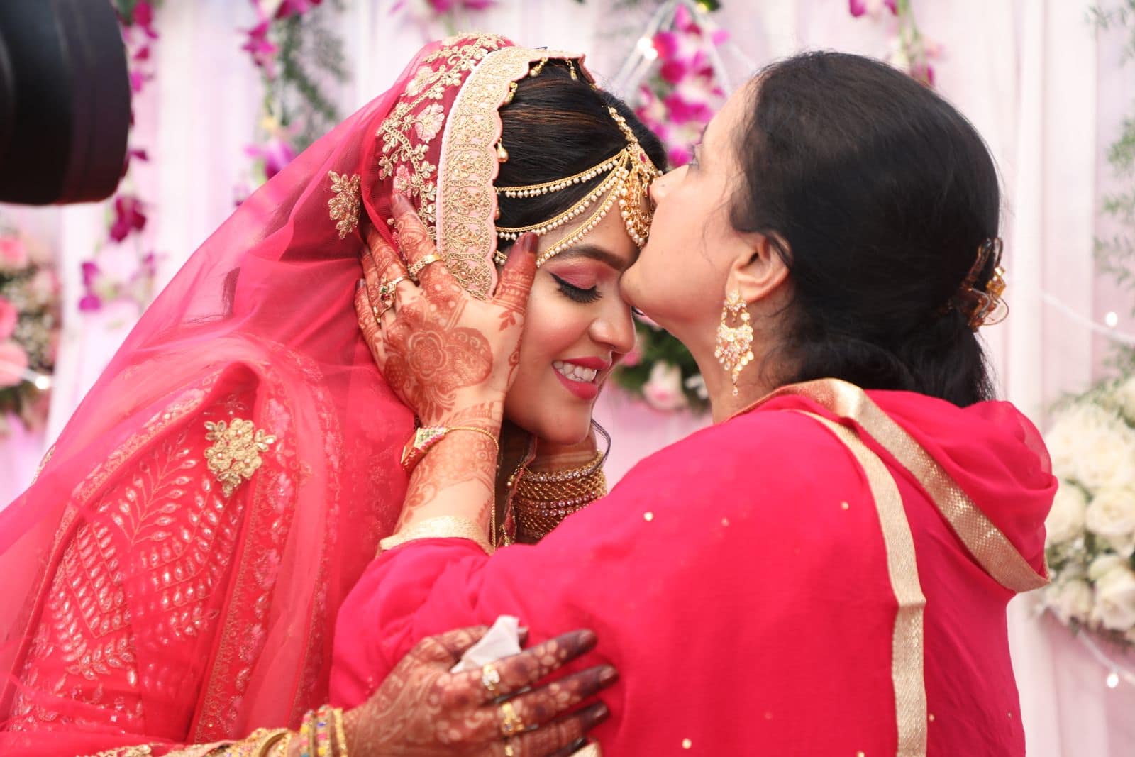 An emotional bride vidaai farewell embrace