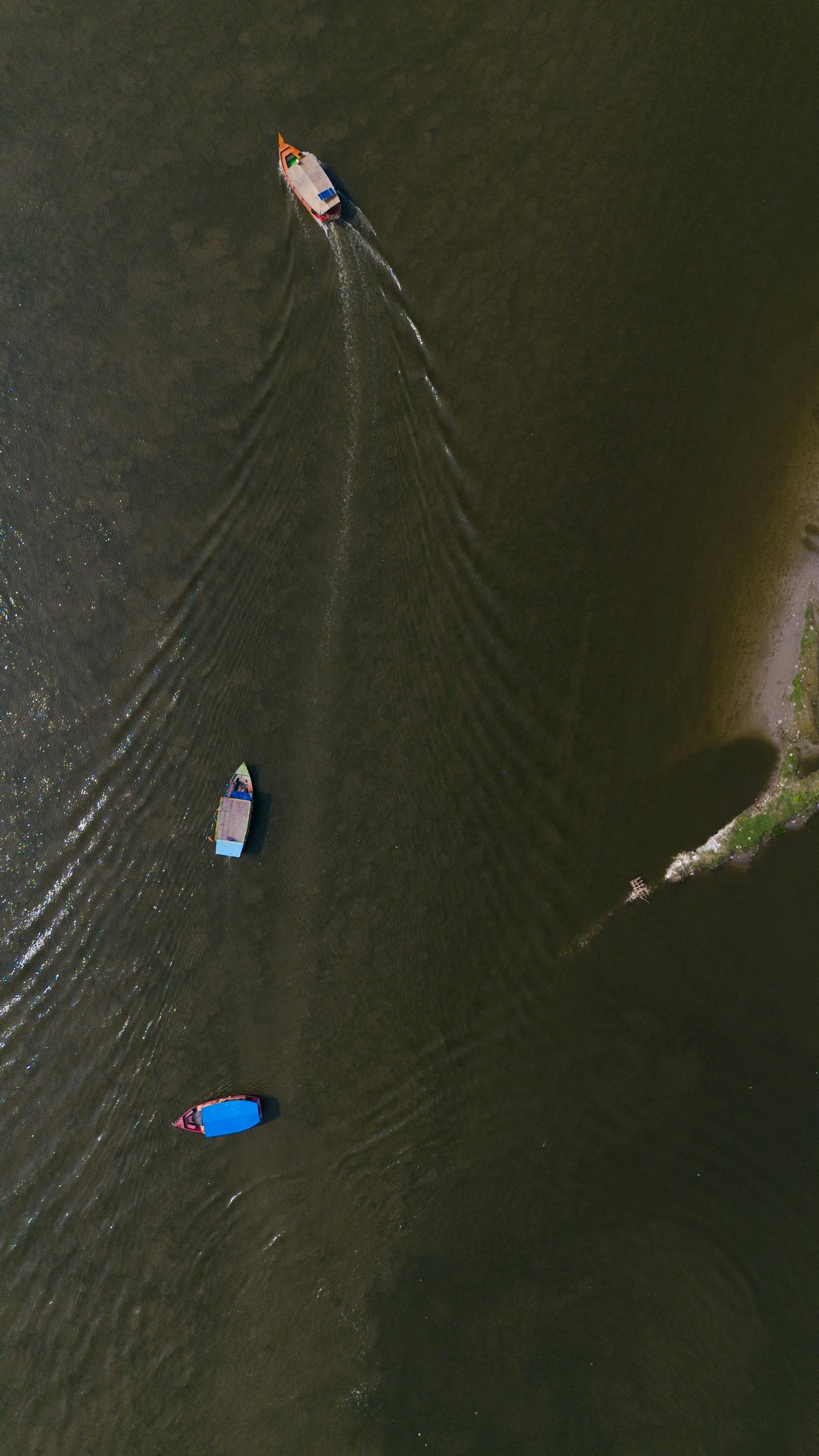 Boats on the Yamuna along the Vrindavan ghats at golden hour